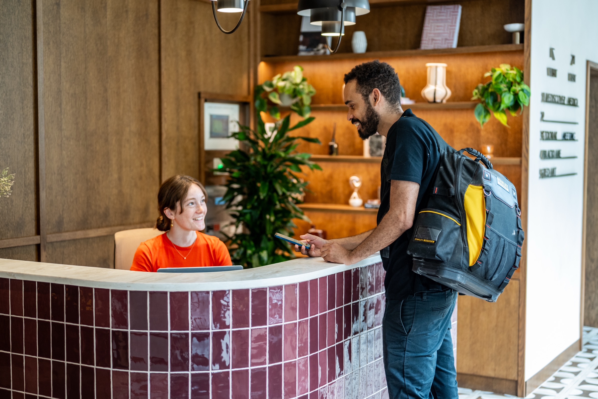 A Reeve engineer checking in at a client reception desk